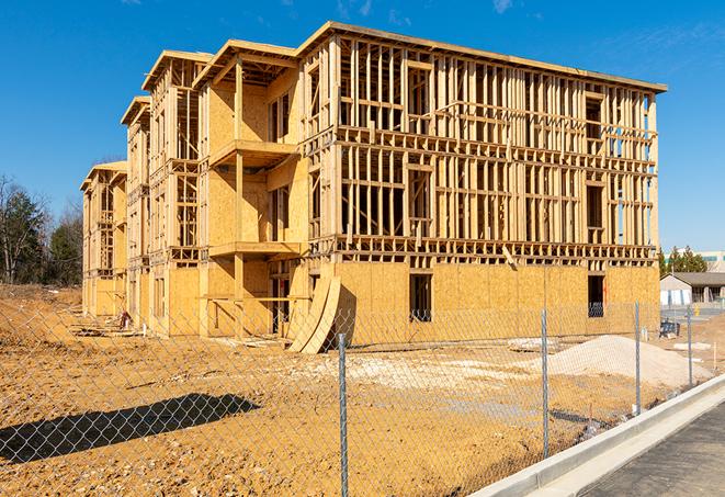 a temporary chain link fence in front of a building under construction, ensuring public safety in Monrovia CA